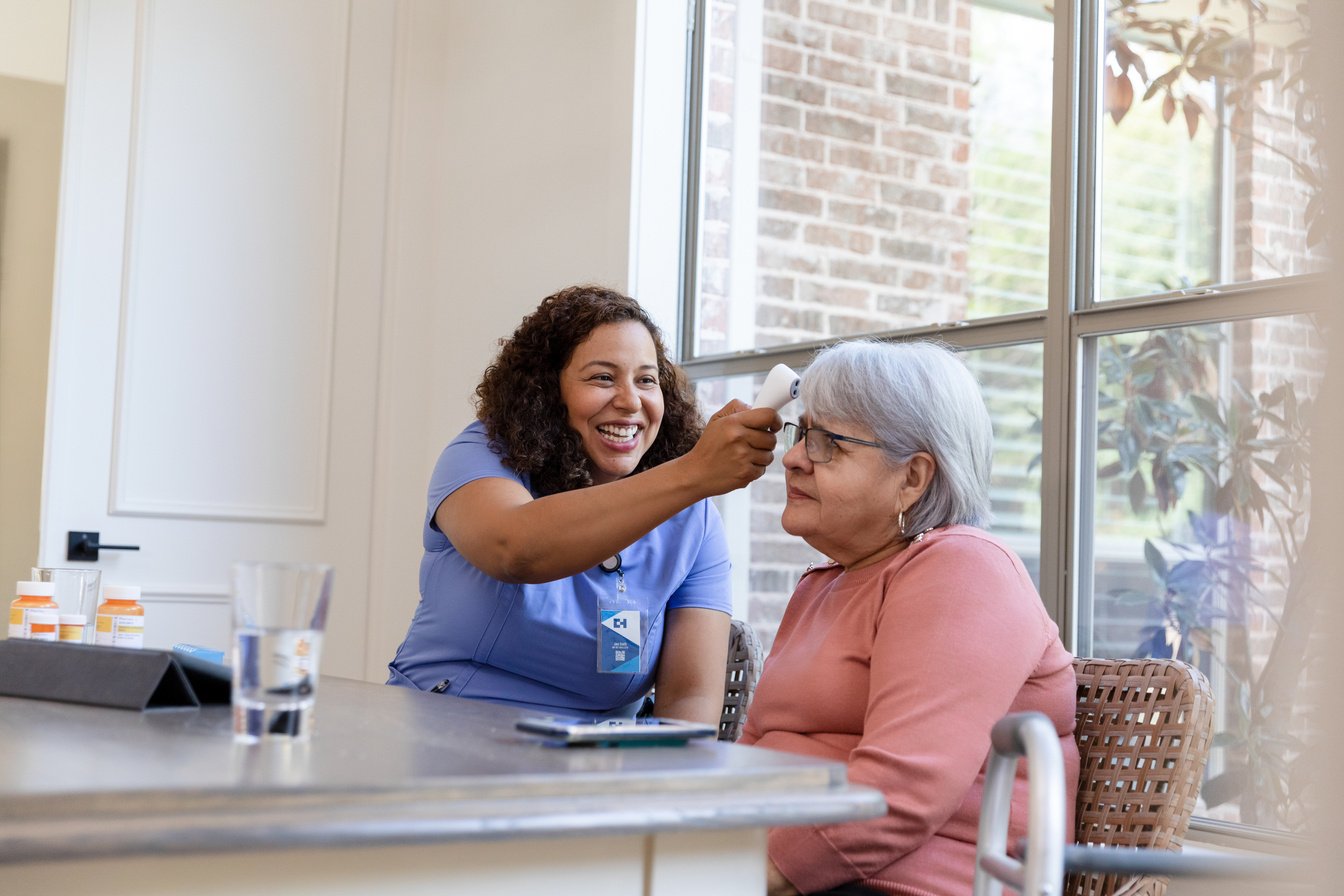 Home health nurse takes temperature